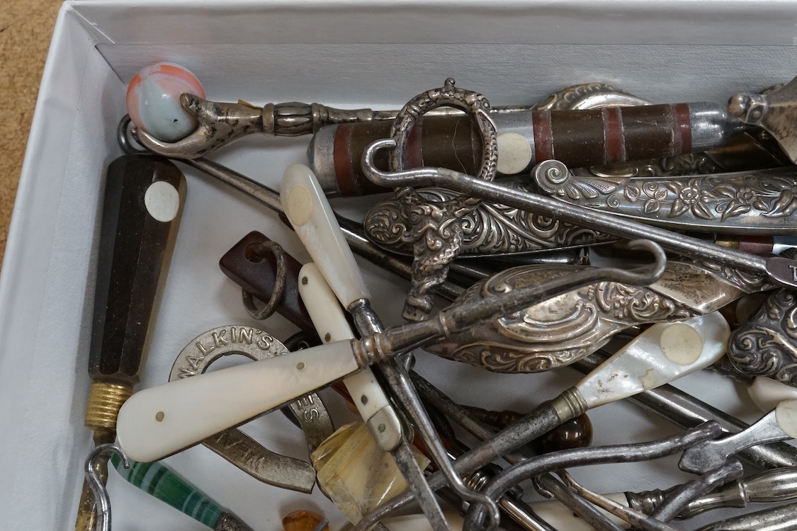 A large collection of Victorian button hooks, with silver, plate, mother of pearl and other handles